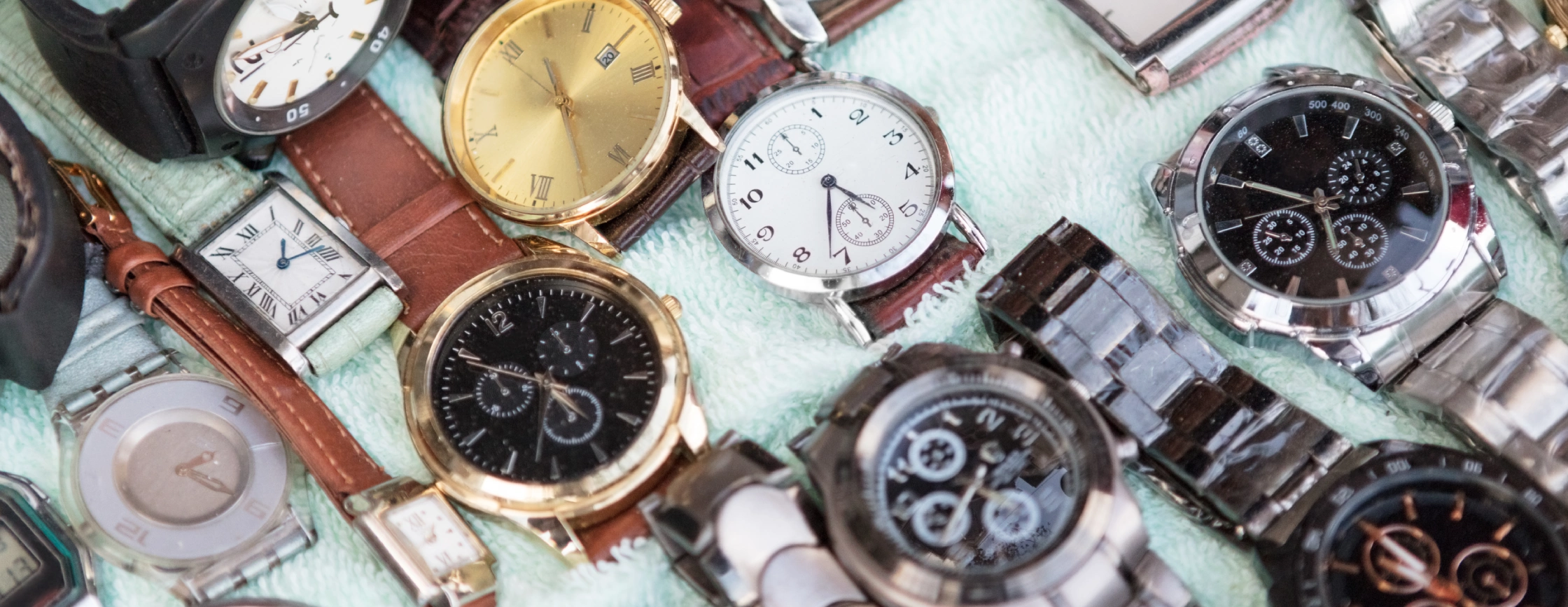 Close-up of various wristwatches with different designs and colors.