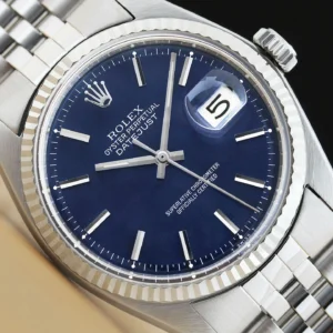 Close-up of a luxury silver wristwatch with a blue dial and date display.